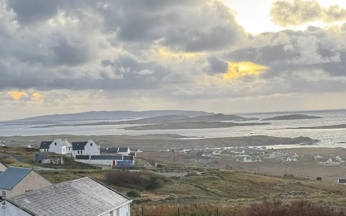 Dusk light breaking through cloud over a bay